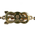 Close-up of 18K gold clasp marked “750” with Mikimoto oyster shell logo, highlighting craftsmanship and authenticity.
