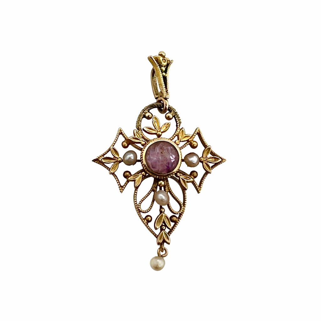 Full front view of an elaborate gold pendant with pearls and a round amethyst stone in the center.