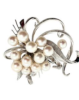 Close-up of Akoya cultured pearl cluster in sterling silver bow brooch