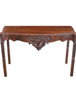 English George III carved mahogany console table, circa 1770, with serpentine top, acanthus‑carved apron, shell motif, and square carved legs.
