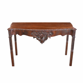 English George III carved mahogany console table, circa 1770, with serpentine top, acanthus‑carved apron, shell motif, and square carved legs.