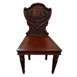 English William IV mahogany hall chair with carved heraldic shield back, horse‑head crest, acanthus foliage, solid seat, and fluted turned legs, circa 1830