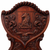 Detail of English William IV mahogany hall chair showing carved heraldic shield with horse‑head motif and surrounding acanthus scrollwork, circa 1830