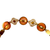 Fine antique gold bracelet with coral stones, braided chain, and Etruscan‑inspired ornamentation