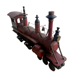 Antique folk art articulated wooden train engine showing cab, wheels, and smokestacks