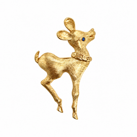 Front view of a vintage 14K yellow gold reindeer pin with a textured Florentine finish and blue sapphire eye
