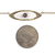 Front view of an Edwardian 14K gold necklace next to a quarter for scale
