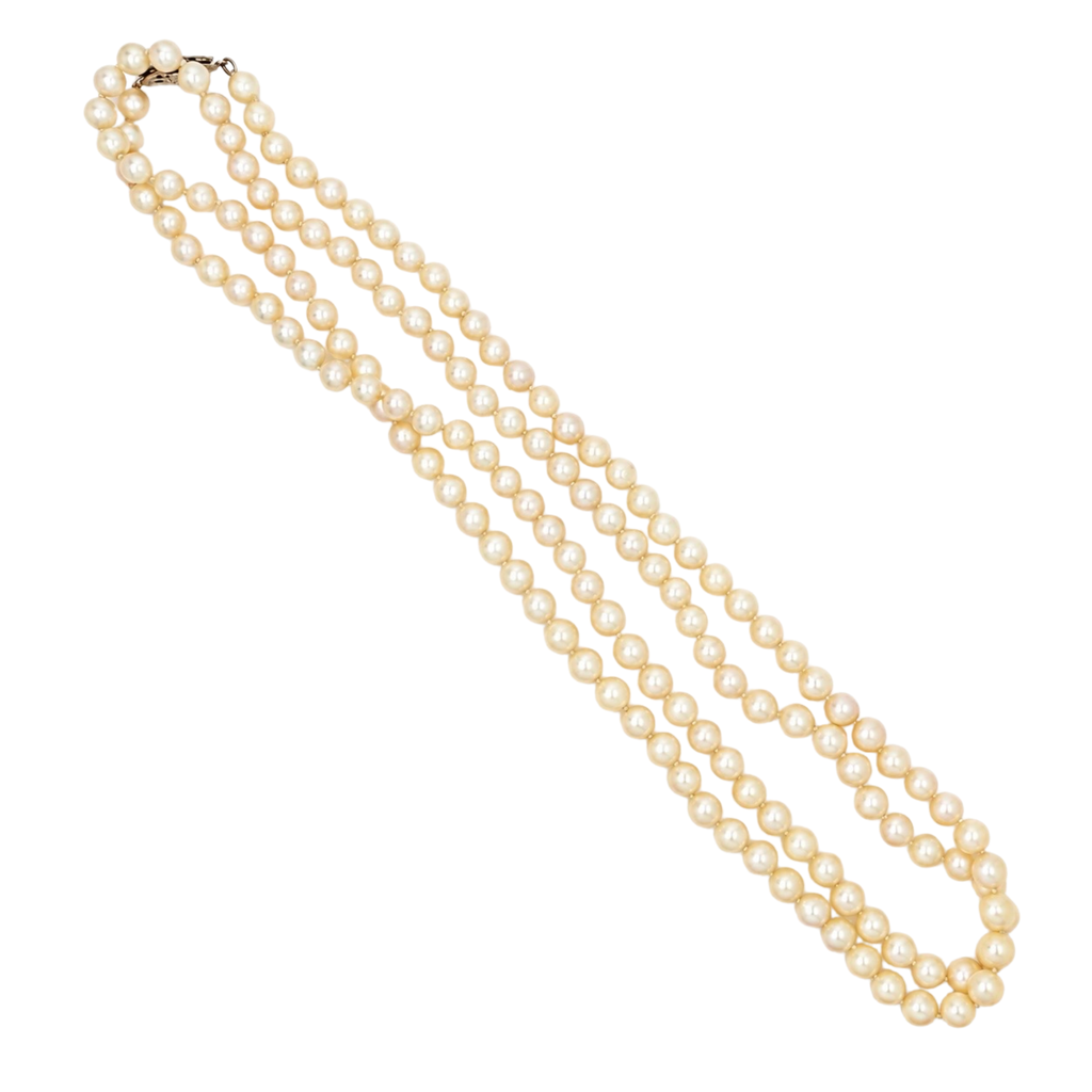 Full 32-inch strand of creamy ivory cultured pearls with a 14K white gold filigree clasp