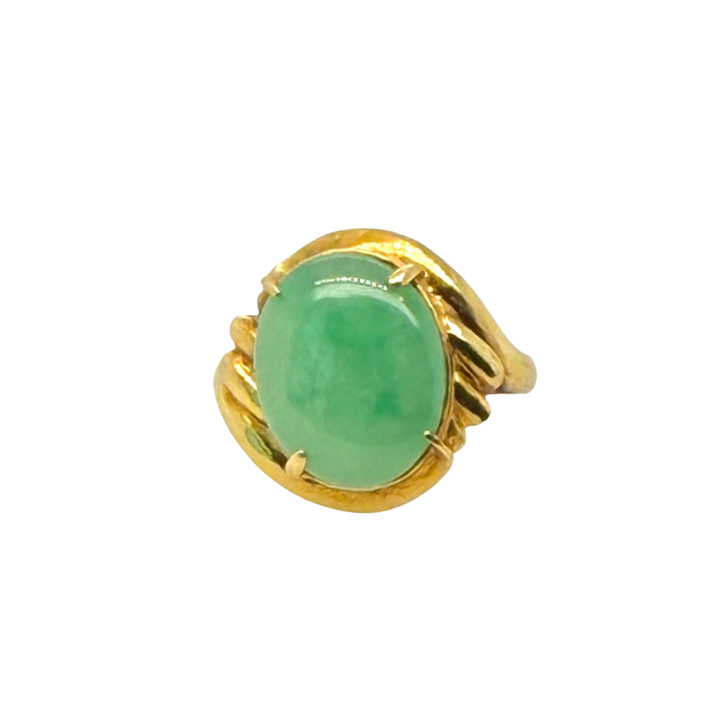 Top view of a vintage 18K yellow gold ring with an oval apple green jade cabochon