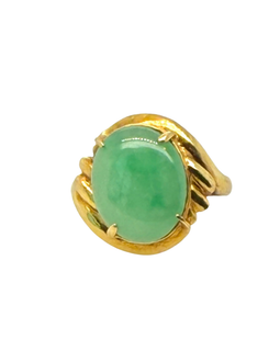 Top view of a vintage 18K yellow gold ring with an oval apple green jade cabochon