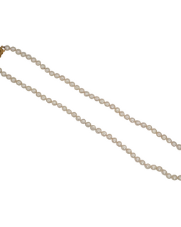 Full view of Mikimoto Akoya cultured pearl necklace with 5 mm pearls and 18K gold clasp, elegantly coiled to show luster and length.