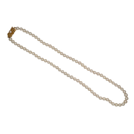 Full view of Mikimoto Akoya cultured pearl necklace with 5 mm pearls and 18K gold clasp, elegantly coiled to show luster and length.