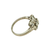 A vintage-style diamond ring in a silver-toned metal band, featuring a cluster of clear gemstones on a plain white background.