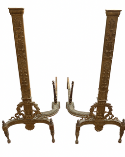 Pair of ornate bronze fire dogs on a white background