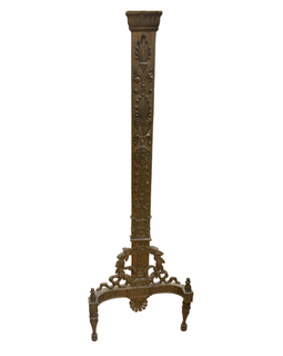 Decorative andiron with intricate designs on a white background