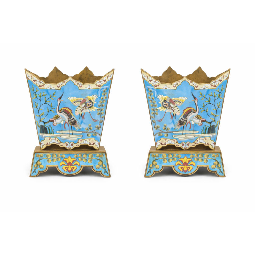 Pair of antique Chinese 19th‑century cloisonné jardenieres with light blue ground, crane and marsh scene, crenelated rims, and flared bases.