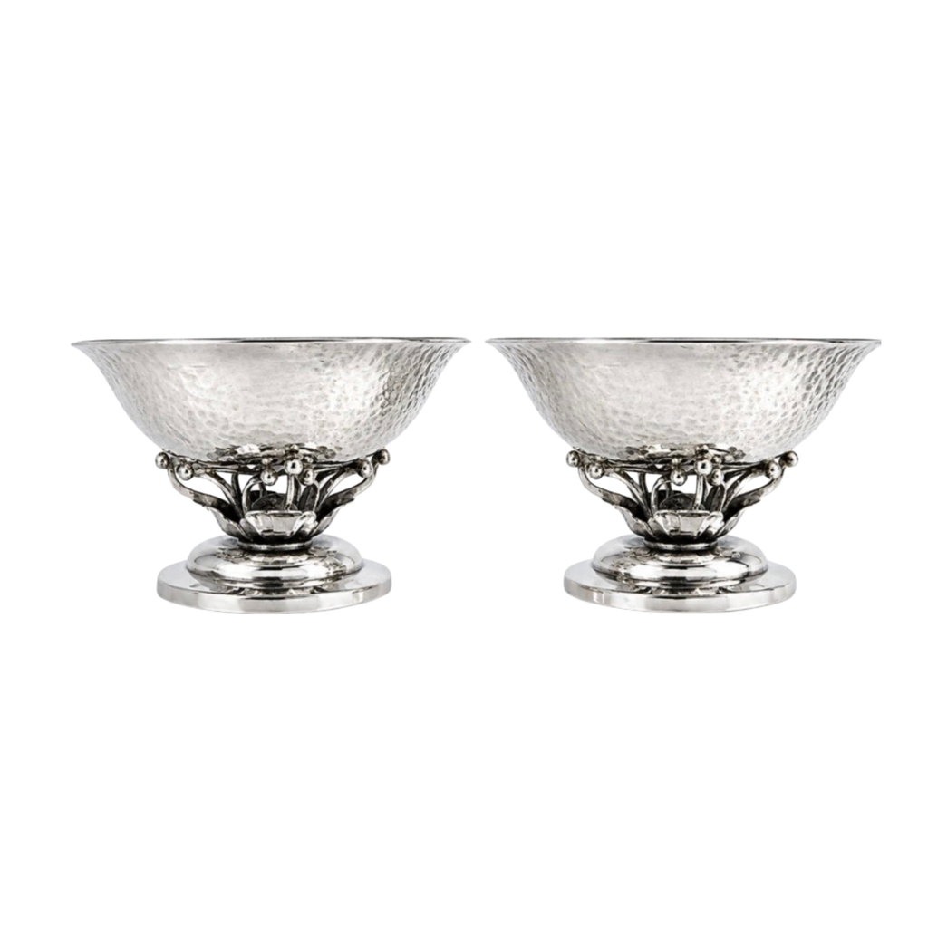 Pair of Georg Jensen sterling silver salts shown together on neutral background