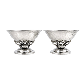 Pair of Georg Jensen sterling silver salts shown together on neutral background