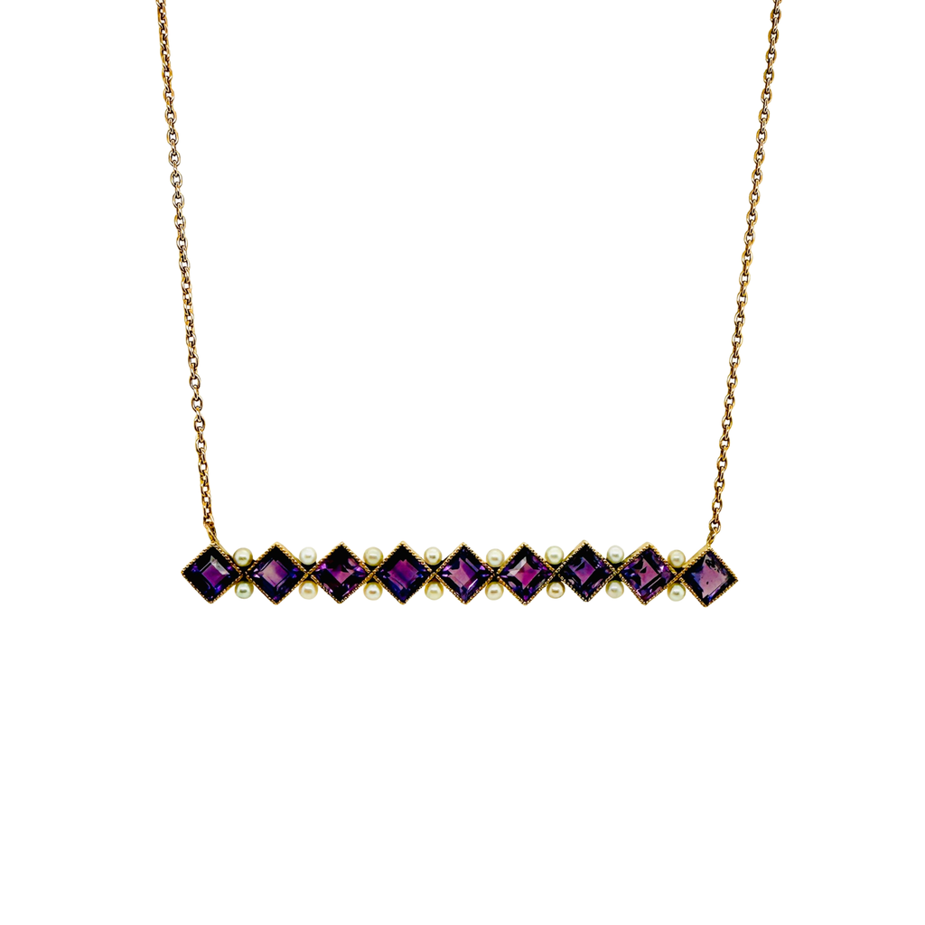 Close‑up of square‑cut amethysts set in gold bezels with alternating seed pearls.