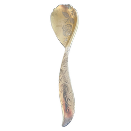 A silver spoon with ornate designs on the handle, displaying a mix of silver and white tones.