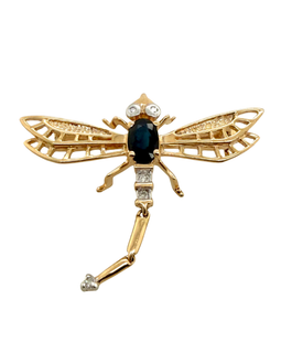 Gold insect brooch with gemstones on a white background
