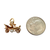 Vintage gold car charm shown next to a coin for scale