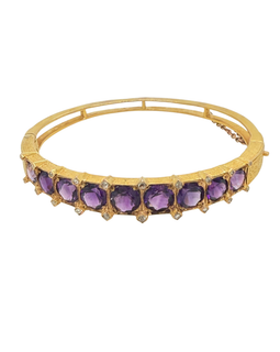 Antique 14K gold amethyst bangle showing prong‑set purple gemstones and safety chain